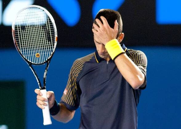 Novak Djokovic of Serbia reacts during his fourth round men s singles match on the seventh day of 2013 Australian Open tennis tournament in Melbourne, Australia, Jan. 20, 2013. Novak Djokovic won 3-2. (Xinhua Bai Xue) (ql) AUSTRALIA-MELBOURNE-TENNIS-MEN S SINGLES 