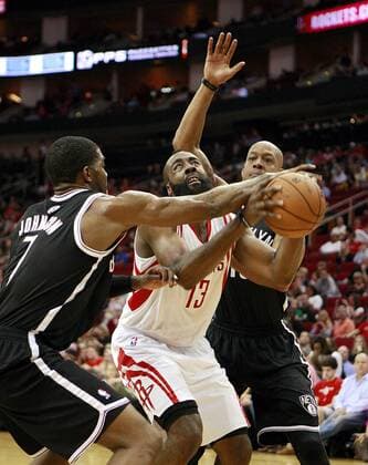 HOUSTON, Jan. 26, 2013 - Houston Rockets James Harden (C) is defended during the NBA Basketball Herren USA basketball game against Brooklyn Nets in Houston, the United States, Jan. 26, 2013. Rockets won 119-106. (Xinhua Song Qiong) U.S.-HOUSTON-NBA-BASKETBALL-ROCKETS VS NETS 