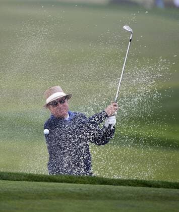 Actor Andy Garcia blasts out of a trap on the sixth hole at the Monterey Peninsula Country Club in the AT&T National Pro Am in Pebble Beach, California on February 7, 2013.  SXP20130200705