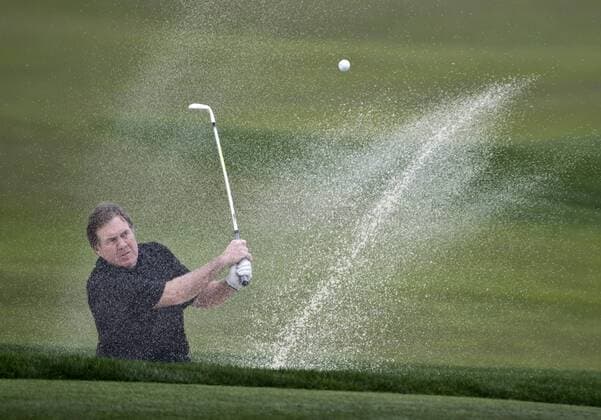 New England Patriots Head Coach Bill Belichick hits out of the sand to the sixth green at the Monterey Peninsula Country Club in the AT&T National Pro Am in Pebble Beach, California on February 7, 2013.  SXP20130200711