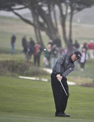 Phil Mickelson chips to the sixth green at the Monterey Peninsula Country Club in the AT&T National Pro Am in Pebble Beach, California on February 7, 2013.  SXP20130200717