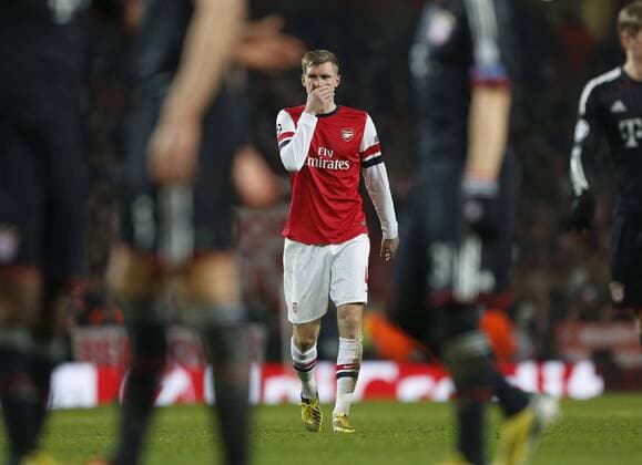 Arsenal s Per Mertesacker looks on dejected..Arsenal v Bayern Munich - Champions League Second Round, First Leg- Emirates Stadium, London- 19 02 13 - Picture David Klein Sportimage EDITORIAL USE ONLY. No use with unauthorised audio, video, data, fixture lists, club league logos or live services. Online in-match use limited to 120 images, no video emulation. No use in betting, games or single club league player publications.