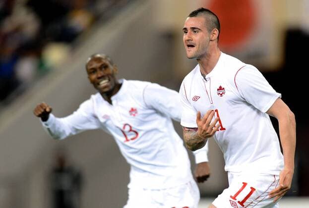 (130323) -- DOHA, March 22, 2013 (Xinhua) -- Marcus Haber (R) of Canada celebrates for his goal during the international friendly match between Japan and Canada at Khalifa Stadium in Doha, Qatar, on March 22, 2013. Japan won 2-1. (Xinhua Chen Shaojin) (lm) QATAR-DOHA-SOCCER-INTERNATIONAL FRIENDLY-JPN VS. CAN 