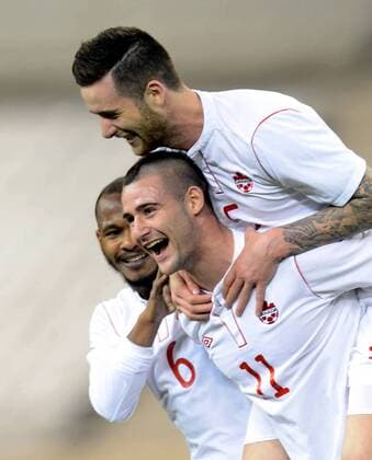 (130323) -- DOHA, March 22, 2013 (Xinhua) -- Marcus Haber (below R) of Canada celebrates for his goal with teammates during the international friendly match between Japan and Canada at Khalifa Stadium in Doha, Qatar, on March 22, 2013. Japan won 2-1. (Xinhua Chen Shaojin) (lm) QATAR-DOHA-SOCCER-INTERNATIONAL FRIENDLY-JPN VS. CAN 