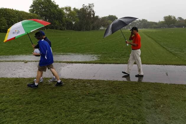 March 24, 2013 - Orlando, Florida, U.S - Spectators walk on the 1st hole during the rain delay on the final round of the Arnold Palmer Invitational at the Bay Hill Club and Lodge. Golf 2013 - Arnold Palmer Invitational - Final Round  - ZUMAr11