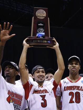 March 31, 2013 - Indianapolis, IN, USA - Louisville guard Peyton Siva (3) hoists the trophy with teammates Louisville guard Russ Smith (2), left, and Louisville forward Wayne Blackshear (20) right, after their win in the NCAA College League USA regional final game on Sunday, March 31, 2013, in Indianapolis, Indiana. Louisville won the game 85-63. (Sam Riche MCT)in the NCAA College League USA regional final game on Sunday, March 31, 2013, in Indianapolis, Indiana. Louisville won the game 85-63. Louisville VS. Duke - ZUMAm67
