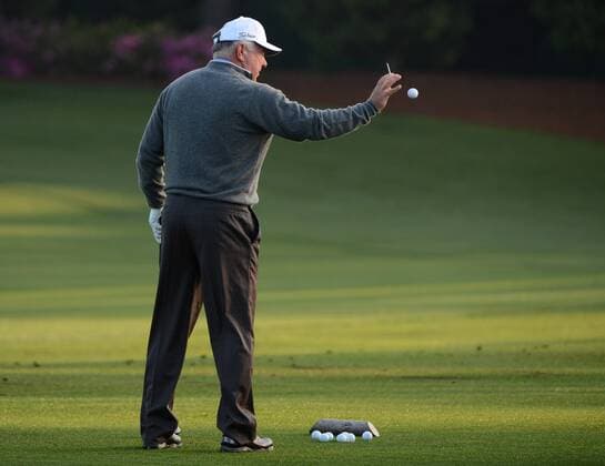 Mark O Meara catches a golf ball thrown by his caddie on the driving range during a practice round before the Masters golf tournament at Augusta National Golf Club on April 8, 2013 in Augusta, Georgia. The 77th Masters tournament will begin on Thursday.  AUG20130408313