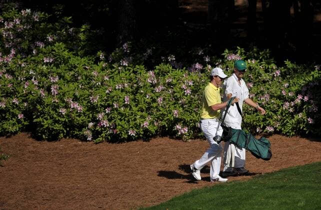 Rory McIlroy and his girlfriend Caroline Wozniacki walk to the 9th green during the Masters Par 3 Contest a day before the beginning of the Masters tournament at Augusta National, on April 10, 2013 in Augusta, Georgia.  AUG20130410320