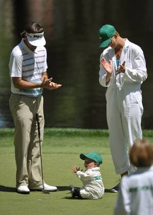 Bubba Watson and his wife Angie clap with their son Caleb on the 9th green during the Masters Par 3 Contest, a day before the beginning of the Masters tournament, at Augusta National, on April 10, 2013 in Augusta, Georgia.  AUG20130410328
