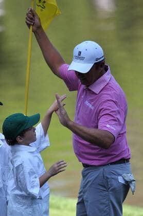 Bo Van Pelt high fives his child during the Masters Par 3 Contest, a day before the beginning of the Masters tournament, at Augusta National, on April 10, 2013 in Augusta, Georgia.  AUG20130410336