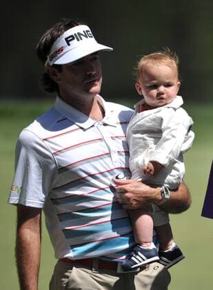 Bubba Watson holds his son Caleb as they walk to the 9th green during the Masters Par 3 Contest, a day before the beginning of the Masters tournament, at Augusta National, on April 10, 2013 in Augusta, Georgia.  AUG20130410352