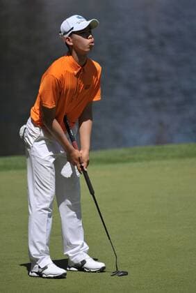 Guan Tianlang of China reacts to a putt on the 9th green during the Masters Par 3 Contest, a day before the beginning of the Masters tournament, at Augusta National, on April 10, 2013 in Augusta, Georgia.  AUG20130410347