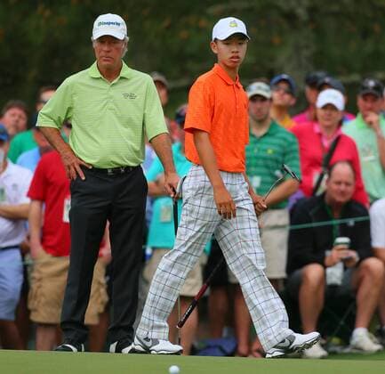 April 12, 2013 - Augusta, GA, USA - Fourteen-year-old amateur Tianlang Guan, right, checks his putt as veteran Ben Crenshaw watches on the No. 1 green during the second round of the Masters Tournament at Augusta National Golf Club, Friday, April 12, 2013, in Augusta, Georgia. Masters Tournament at Augusta National - ZUMAm67
