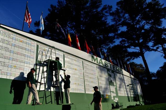 Workers set the scoreboard before the start of the third round of the Masters at Augusta National on April 13, 2013 in Augusta, Georgia.  AUG20130413302