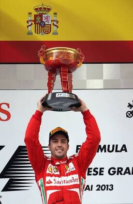 (130414) -- SHANGHAI, April 14, 2013 (Xinhua) -- Ferrari driver Fernando Alonso holds up the trophy as he celebrates on the podium after winning the Formula One Chinese Grand Prix at the Shanghai International circuit, in Shanghai, east China, on April 14, 2013. (Xinhua Fan Jun) CHINA-SHANGHAI-F1 (CN) 