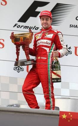 (130414) -- SHANGHAI, April 14, 2013 (Xinhua) -- Ferrari driver Fernando Alonso holds up the trophy as he celebrates on the podium after winning the Formula One Chinese Grand Prix at the Shanghai International circuit, in Shanghai, east China, on April 14, 2013. (Xinhua Fan Jun) CHINA-SHANGHAI-F1 (CN) 