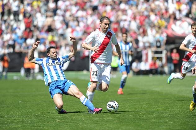 player Rayo Vallecano Foward Andrija Andrija Andrija Delibasic (23) and Alberto de La Bella during Rayo Vallecano - Real Sociedad San Sebastian round 31 league BBVA at Madrid Spain on April 14 2013 