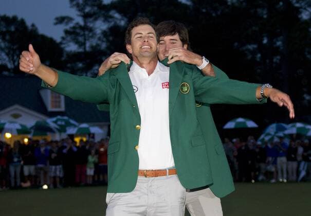 Bubba Watson, 2012 Masters winner, puts the green jacket onto Adam Scott after he won the 2013 Masters at Augusta National on April 14, 2013 in Augusta, Georgia. Scott defeated Angel Cabrera on a 10th hole playoff.  AUG20130414316
