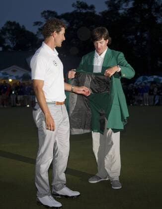 Bubba Watson (R), 2012 Masters winner, puts the green jacket onto Adam Scott after he won the 2013 Masters at Augusta National on April 14, 2013 in Augusta, Georgia. Scott defeated Angel Cabrera on a 10th hole playoff.  AUG20130414317