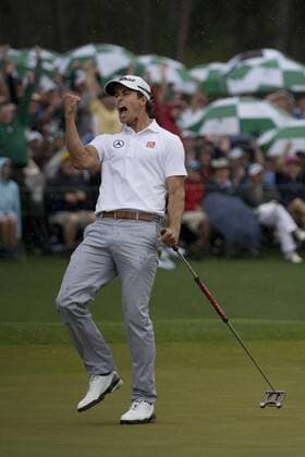 Adam Scott celebrates after making a putt for birdie on the 18th green before going on to win the 2013 Masters at Augusta National on April 14, 2013 in Augusta, Georgia. Scott defeated Angel Cabrera on a 10th hole playoff.  AUG20130414322