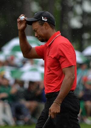 Tiger Woods walks on the 18th green after hitting from a bunker on the 18th hole during the final round of the Masters at Augusta National on April 14, 2013 in Augusta, Georgia. Tiger finished fourth with a four day total of 283. Adam Scott of Australia won after defeating Angel Cabrera in a playoff.  AUG20130414338