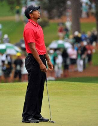 Tiger Woods reacts after missing a putt on the seventh hole in the fourth round of the Masters at Augusta National on April 14, 2013 in Augusta, Georgia.  AUG20130414503
