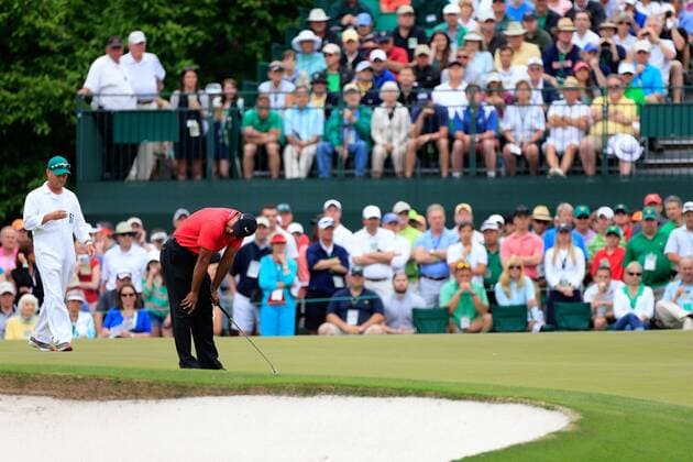 AUGUSTA, April 14, 2013 -- Tiger Woods of the United States reacts during the fourth round of the 2013 Masters golf tournament at the Augusta National Golf Club in Augusta, Georgia, the United States, April 14, 2013. Woods finished the tournament at five-under par 283. (Xinhua Sam Greenwood Augusta National) U.S.-AUGUSTA-GOLF-2013 MASTERS 
