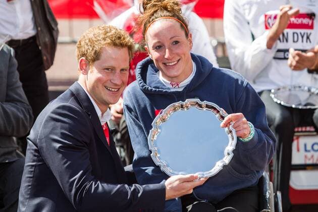 21.04.2013 London, England. HRH Prince Harry presents a trophy to women s wheelchair winner (Tatyana McFadden (USA) following the The Virgin London Marathon. xDavidxFearnx  ActionPlus11399767