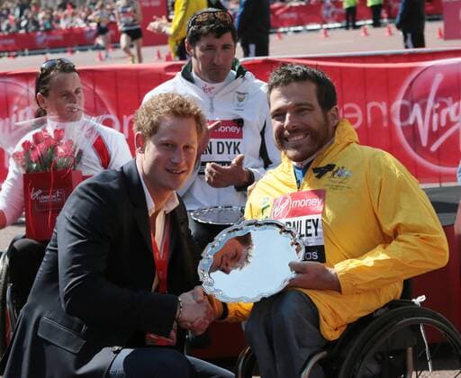 HRH Prince Harry congratulates Australia s Kurt Fearnley after he won the 2013 London Marathon wheelchair race in a time of 01:31:29 with Switzerland s Marcel Hug (R) second in London on April 21 2013.  LON2013042106
