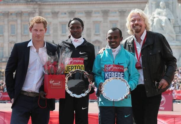 HRH Prince Harry and Virgin CEO Sir Richard Branson stand side by side with the Men and Womens 2013 London Marathon winners Kenya s Priscah Jeptoo and Ethiopia s Tsegaye Kebede at the 2013 London Marathon in London on April 21 2013.  LON2013042110