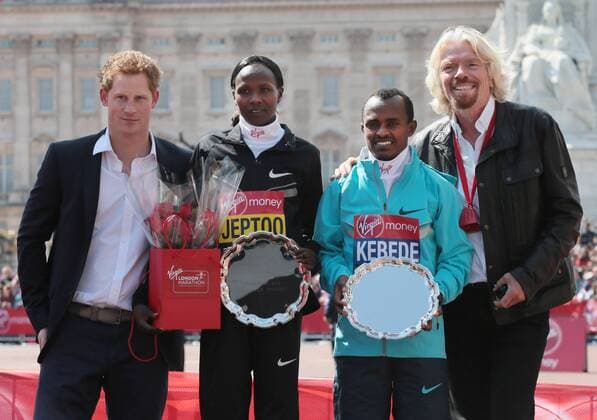 HRH Prince Harry and Virgin CEO Sir Richard Branson stand side by side with the Men and Womens 2013 London Marathon winners Kenya s Priscah Jeptoo and Ethiopia s Tsegaye Kebede at the 2013 London Marathon in London on April 21 2013.  LON2013042114