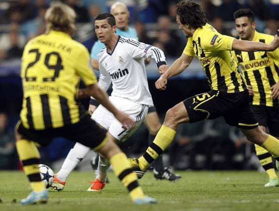 Real Madrid s Cristiano Ronaldo and Borussia s Marcel Schmelzer (l), Mats Hummels during the semi final Champion League match. April 30, 2013.  (201304300038)