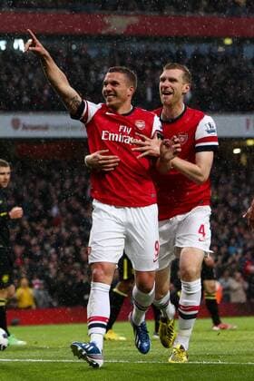 Football - 2012 2013 Premier League - Arsenal vs Wigan Lukas Podolski of Arsenal celebrates scoring his team s 1st goal at the Emirates Stadium, London 