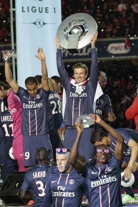 Paris Saint Germain midfielder David Beckham holds up the league trophy during the ceremony for the French league title after the French L1 football match between Paris St Germain (PSG) and Stade Brest on May 18, 2013 at Parc des Princes stadium in Paris. 