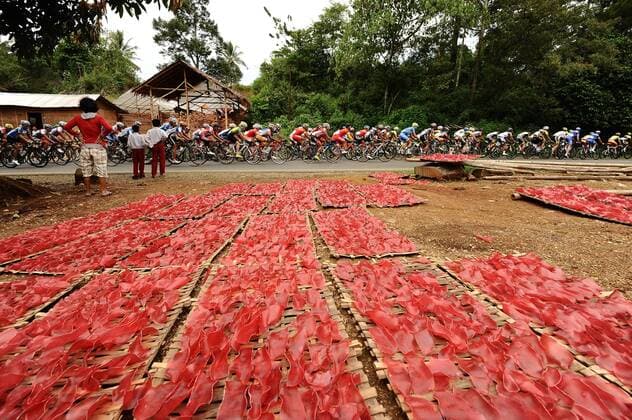 June 3, 2013, Payakumbuh, Indonesia : Riders speeding through a red crackers factory in Payakumbuh on Stage 2 Tour de Singkarak 2013 (Payakumbuh-Lake Singkarak).  ( 20243)