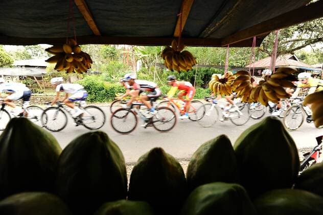 June 3, 2013, Payakumbuh, Indonesia : Riders speeding through fruit seller in Payakumbuh on Stage 2 Tour de Singkarak 2013 (Payakumbuh-Lake Singkarak).  ( 20245)