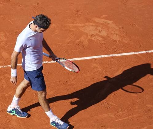 Roger Federer of Switzerland pauses at Roland Garros in Paris on June 4, 2013.  PAR20130604713