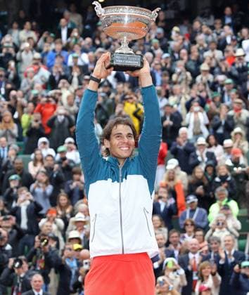 Spaniard Rafael Nadal holds the championship trophy after winning his French Open men s final match at Roland Garros in Paris on June 9, 2013. Nadal become the first player ever to win the same Grand Slam tournament eight times.  PAR20130609707