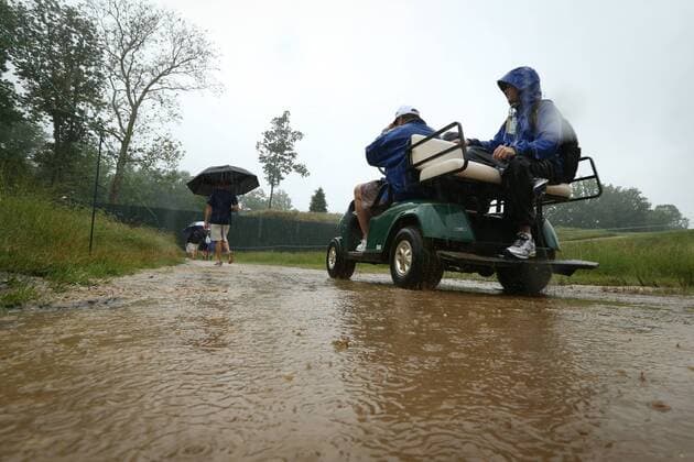 June 10 2013: Heavy rains flood the pathways as a golf cart drives threw the water during monday s practice round at the 2013 U.S. Open hosted by Merion Golf Club in Ardmore, PA. GOLF: JUN 10 PGA Golf Herren - U.S. Open - Monday Practice Round Icon131832 EDITORIAL USE ONLY