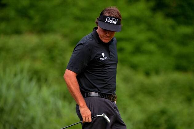 Phil Mickelson reacts after missing a putt on the 11th green during the first round of the 113th U.S. Open Championship at Merion Golf Club in Ardmore, Pennsylvania on June 12, 2013.  PHI20130613321