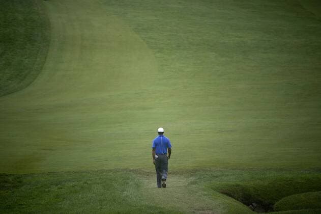 Tiger Woods walks down the 2nd fairway during the first round of the 113th U.S. Open Championship at Merion Golf Club in Ardmore, Pennsylvania on June 13, 2013.  PHI20130613349