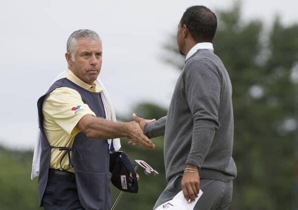 Tiger Woods shakes hands with Adam Scott s caddie Steve Williams during the continuation of the first round of the 113th U.S. Open Championship at Merion Golf Club in Ardmore, Pennsylvania on June 14, 2013.  PHI20130614304