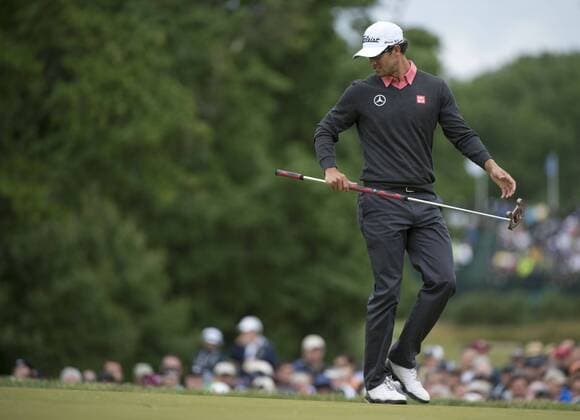 Adam Scott lines up a putt on the 18th green during the continuation of the first round of the 113th U.S. Open Championship at Merion Golf Club in Ardmore, Pennsylvania on June 14, 2013.  PHI20130614306