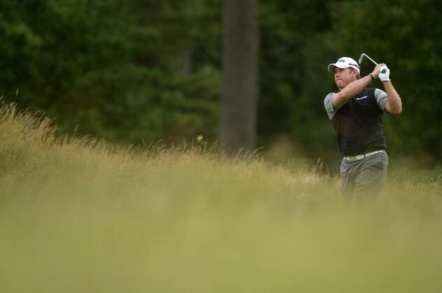 Lee Westwood watches his hit on the 14th fairway during the second round 113th U.S. Open Championship at Merion Golf Club in Ardmore, Pennsylvania on June 14, 2013.  PHI20130614322