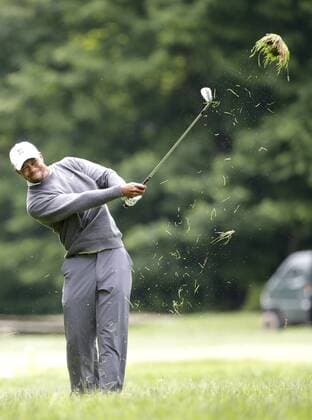 Tiger Woods hits a ball out of the rough on the 12th hole in the second round at the 113th U.S. Open at Merion Golf Club in Ardmore, Pennsylvania on June 14, 2013.  PHI20130614105