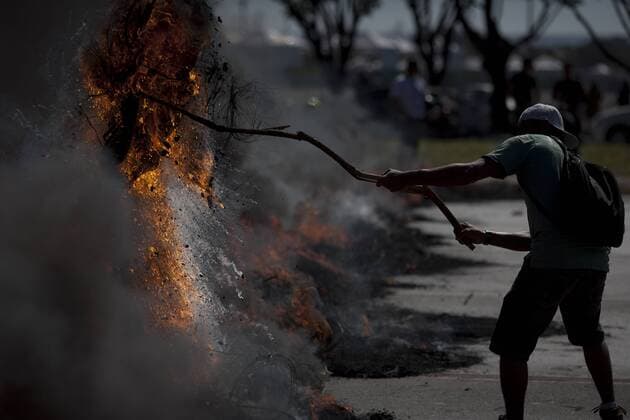 A man attends a protest in front of the Mane Garrincha National Stadium, in Brasilia, Brazil, on June 14, 2013. (Xinhua Guillermo Arias) (py) (SP)BRAZIL-BRASILIA-CONFEDERATIONS-PROTEST 