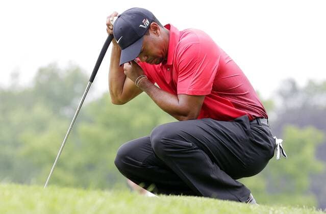 Tiger Woods puts his head down lining up a putt on the 8th green in the Final Round at the 113th U.S. Open at Merion Golf Club in Ardmore, Pennsylvania on June 16, 2013.  PHI20130616105