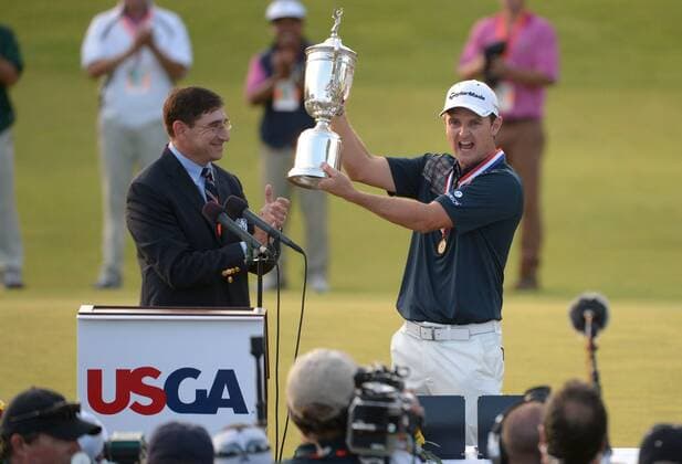 Justin Rose holds up the USA Open Championship Trophy as USGA Commissioner Glen Nager applauds after Rose won the 113th U.S. Open Championship at Merion Golf Club in Ardmore, Pennsylvania on June 16, 2013.  PHI20130616315