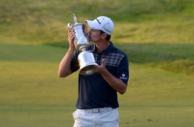 Justin Rose holds up the USA Open Championship Trophy after winning the 113th U.S. Open Championship at Merion Golf Club in Ardmore, Pennsylvania on June 16, 2013.  PHI20130616319