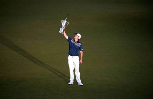 Justin Rose holds up the USA Open Championship Trophy after winning the 113th U.S. Open Championship at Merion Golf Club in Ardmore, Pennsylvania on June 16, 2013.  PHI20130616338